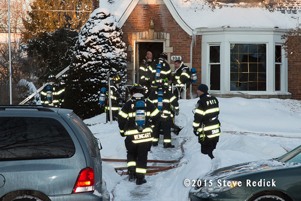 firemen at a winter house fire