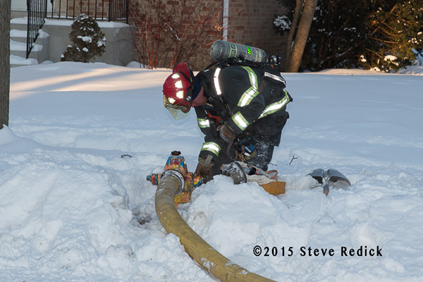 fireman at hydrant buried by snow