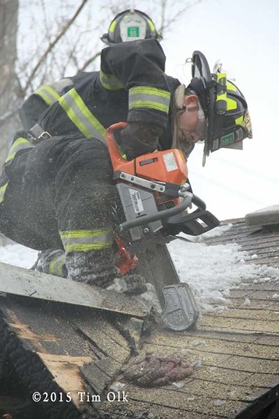 fireman cuts roof with saw