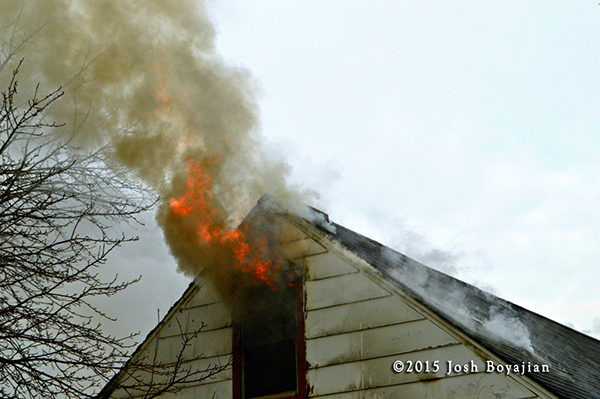flames from attic of house on fire