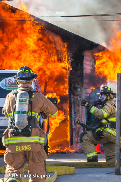 fireman gets ready to fight fully engulfed garage fire