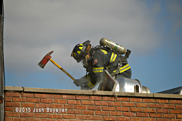 fireman on roof at commercial fire