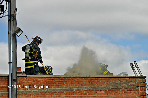 firemen on roof at commercial fire