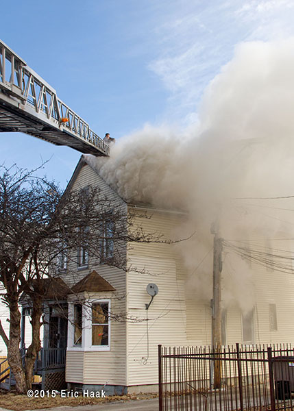 aerial ladder to roof of smokey house fire