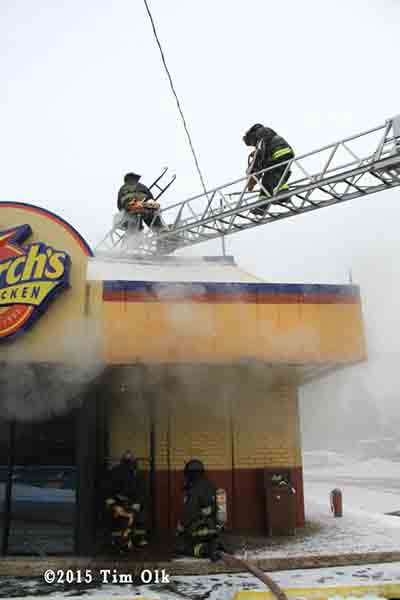firemen on aerial ladder with stripping ladder