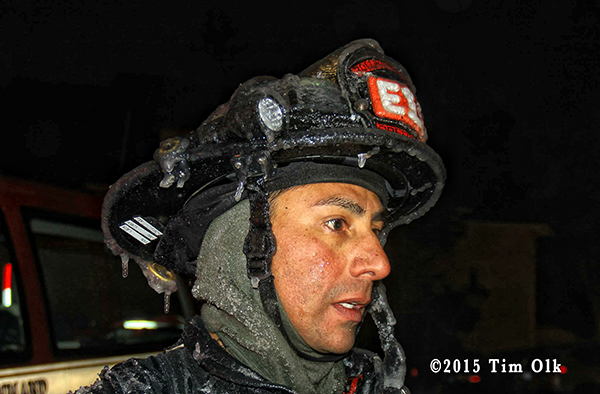 fireman covered with ice at winter fire scene