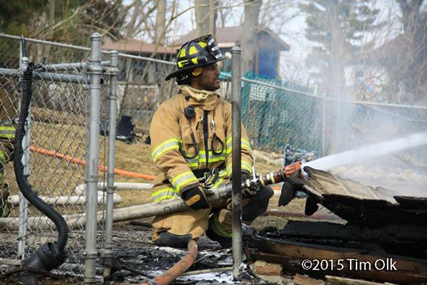 fireman with hose at fire scene