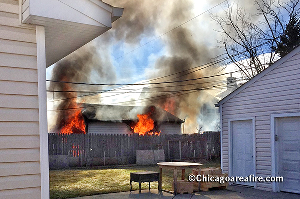 flames from detached garage on fire
