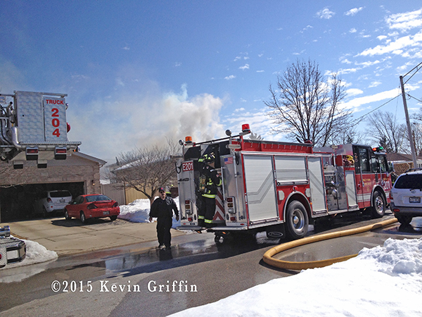 Firemen in Tinley Park (IL) at the scene of a house fire 3/7/15