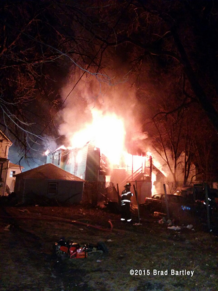 house engulfed in flames at night
