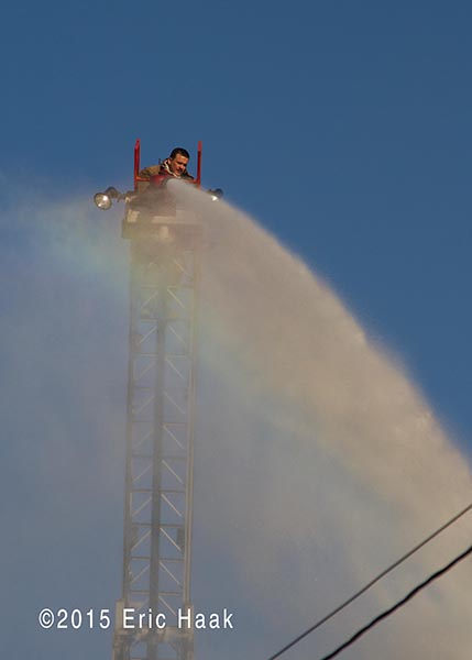 fireman on aerial ladder at fire scene