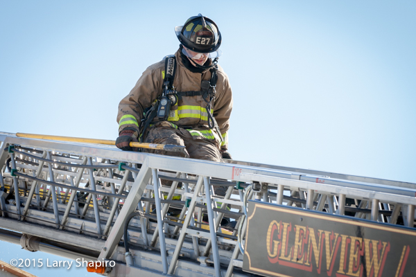 fireman climbing aerial ladder