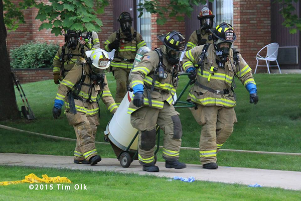 firemen remove hazardous chemical from building