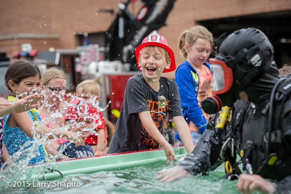 kids having fun during a demonstration of a fire department diver