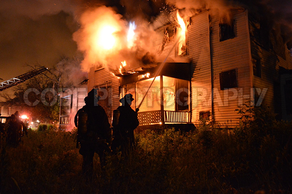 silhouette of firemen at night