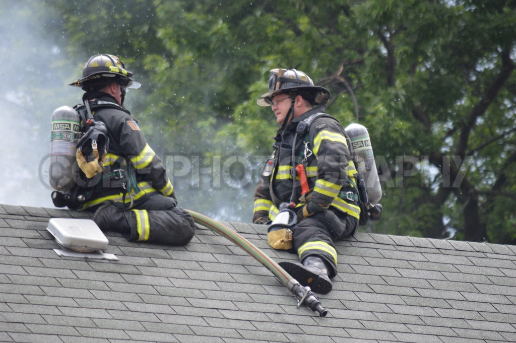 firemen on roof during house fire