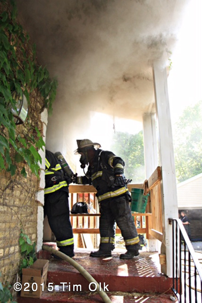 firemen enter house with smoke
