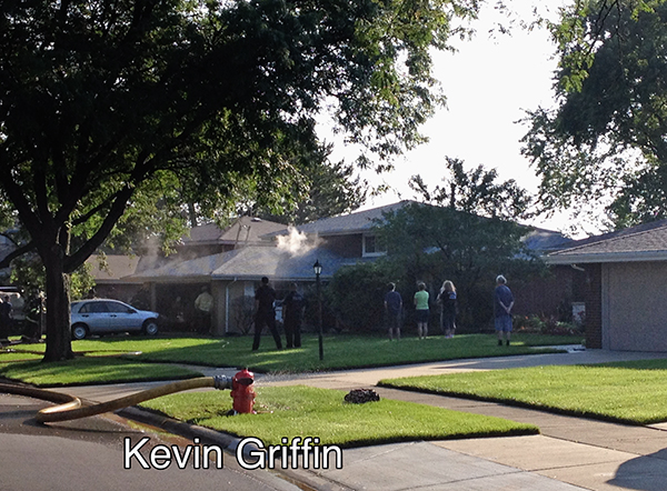firemen on the scene of a small garage fire