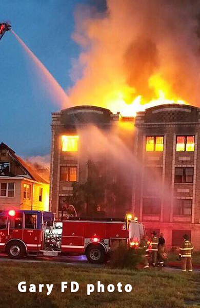 vacant 4-story building fully engulfed in fire