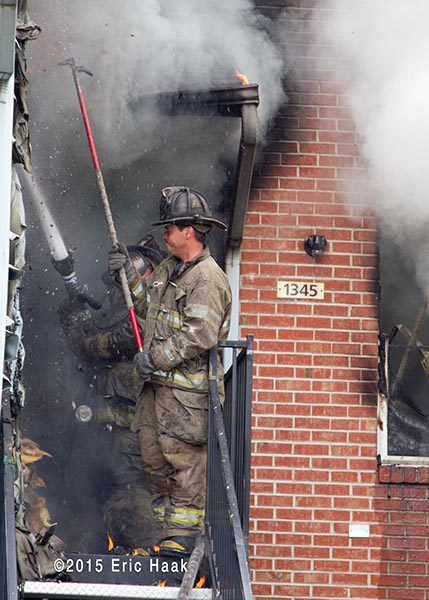 firemen in doorway with heavy smoke