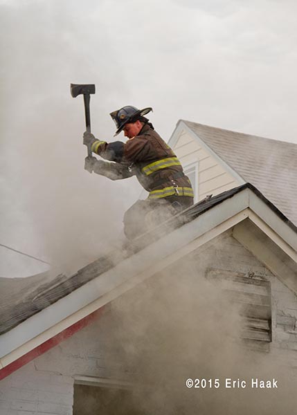 fireman o roof with smoke