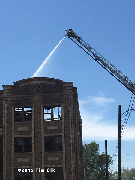 fire department aerial ladder at ruins of huge fire