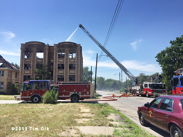 fire department aerial ladder at ruins of huge fire