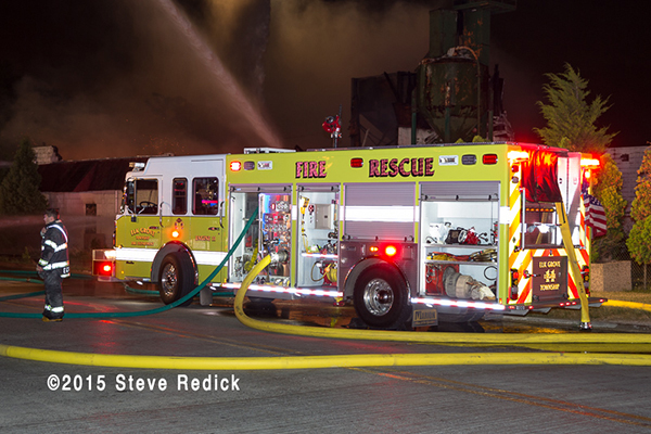 night fire scene with fire trucks