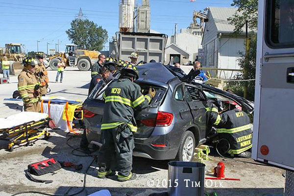 firefighters work to free a driver after a crash