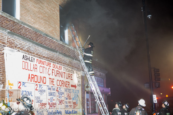 fireman on ladder with heavy smoke
