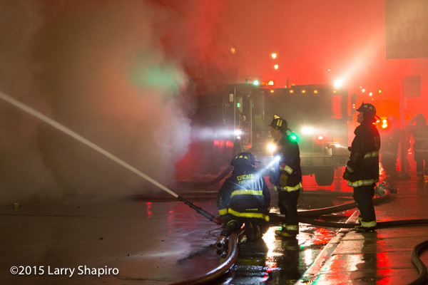 firemen silhouetted at night fire scene