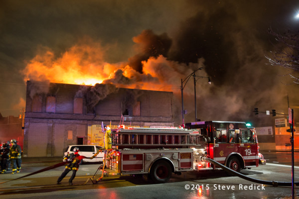 commercial building on fire at night
