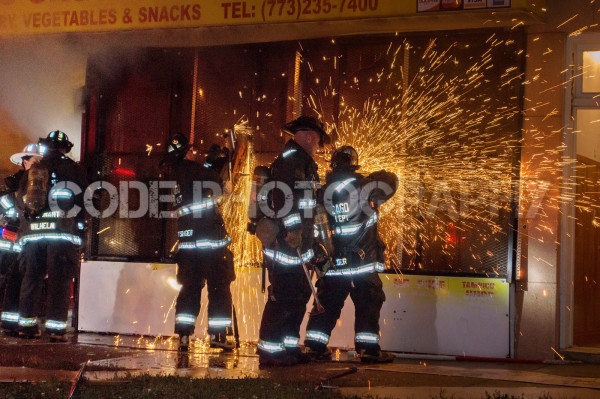 firefighters cut steel gates with saw at night 