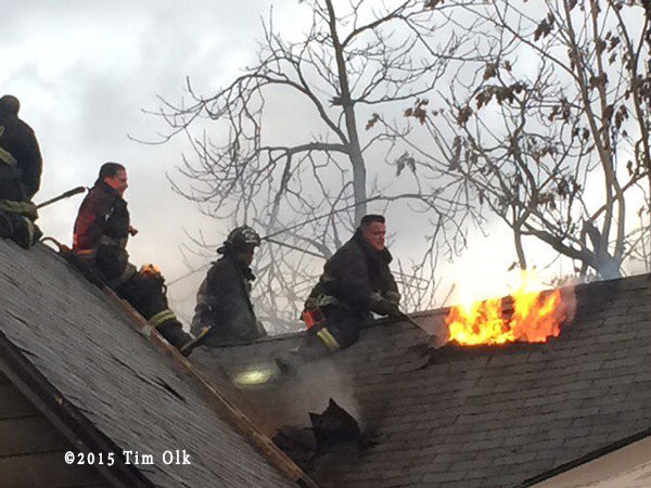 firefighters vent peaked house roof
