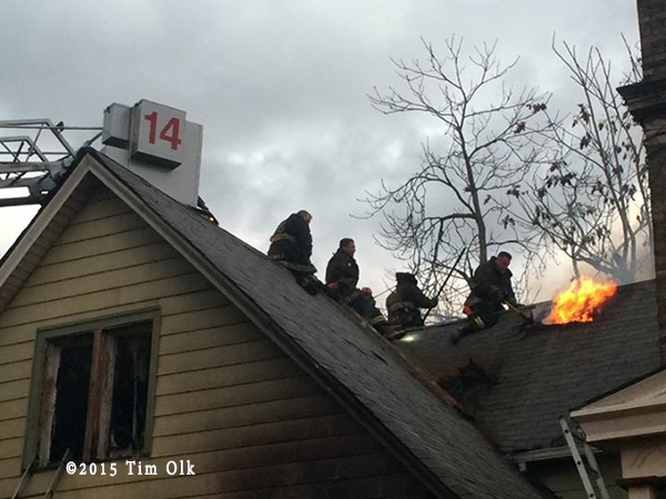 firefighters vent peaked house roof