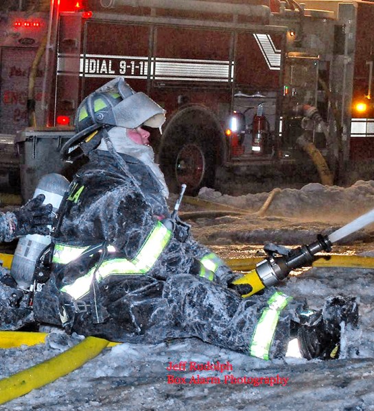 female firefighter coated with ice at fire scene