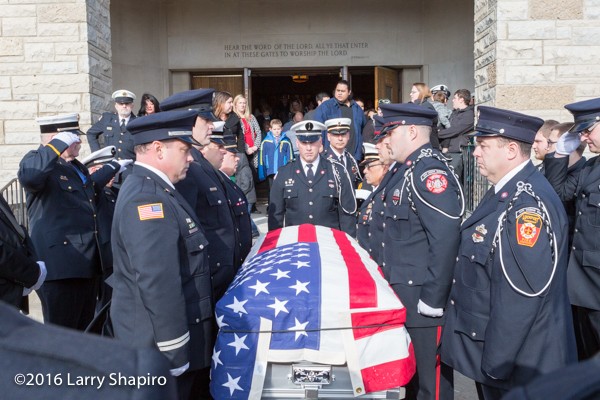 fire department honor guard carries casket