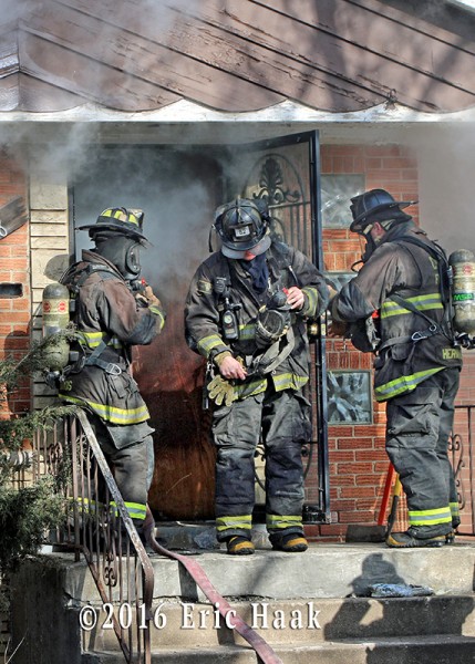 firefighters make entry to house fire