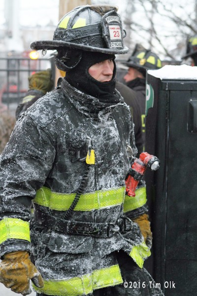 firefighter coated with ice at winter fire
