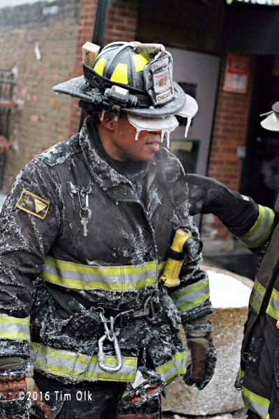 firefighter coated with ice at winter fire