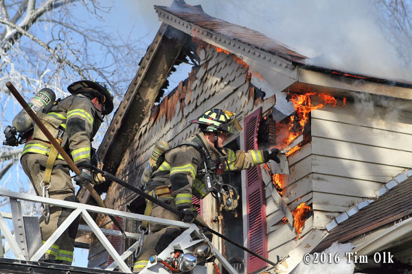 firefighters overhaul from ladder tip