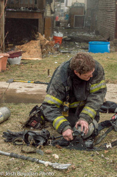 firefighter changes air bottle at fire