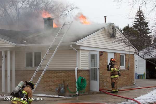 heavy smoke and flames from house on fire