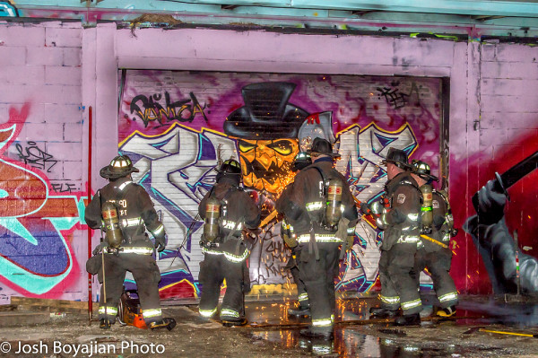 graffiti covered building on fire