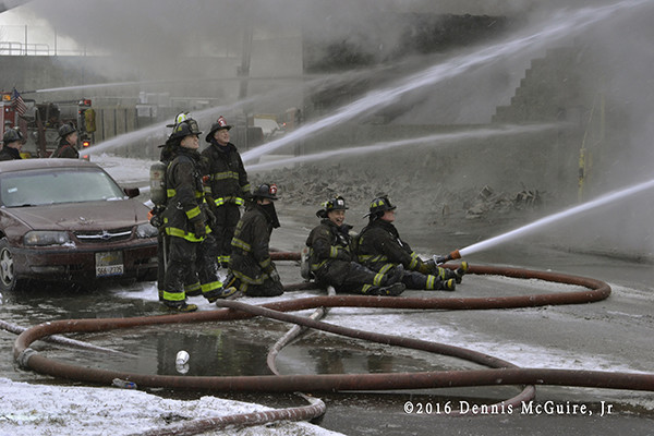 firefighters operate master stream at fire scene