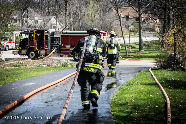 firefighter pulling hose