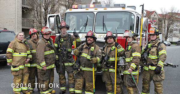 firefighters pose after battling a fire