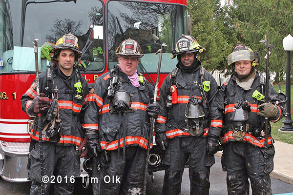 firefighters pose after battling a fire