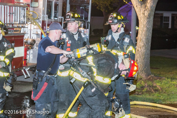 firefighters change air bottle at scene