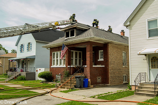 firemen on roof after house fire
